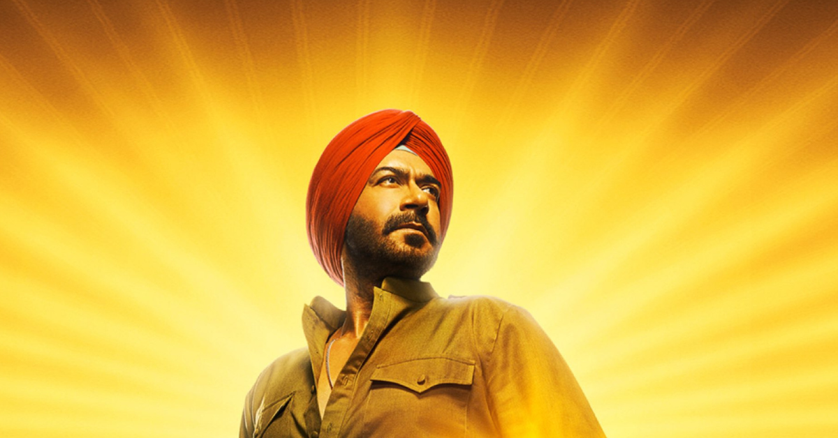 Son of Sardaar 2' के पोस्टर में अजय देवगन, पगड़ी पहने और दमदार अंदाज़ में, पीछे से आती सुनहरी रोशनी में चमकते हुए।