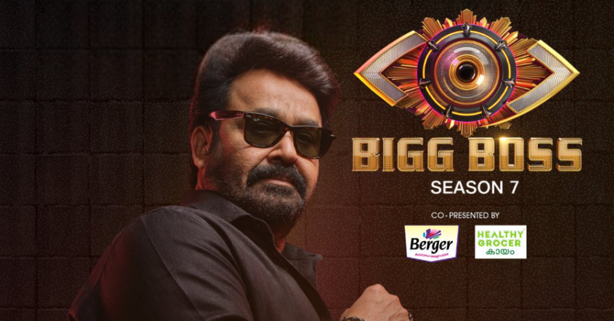 मोहनलाल Bigg Boss Malayalam Season 7 पोस्टर में, शो का लोगो और स्पॉन्सर ब्रांड्स के साथ
